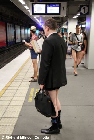 Badly dressed Down Under: A commuter in Sydney clutches his briefcase as he goes without trousers on the train