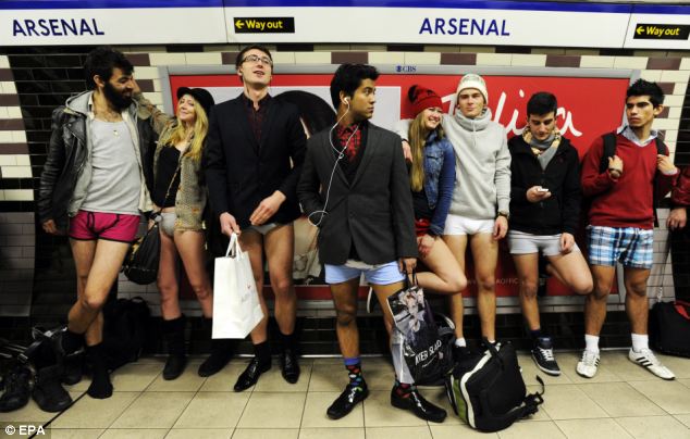 Chilly: Commuters wait for a train to come along at Arsenal tube station, but there's one thing missing - their trousers