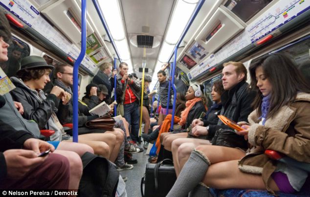 Say cheese: Other fully-clothed commuters take pictures of fellow passengers who are just in their pants on a packed Picadilly Line train