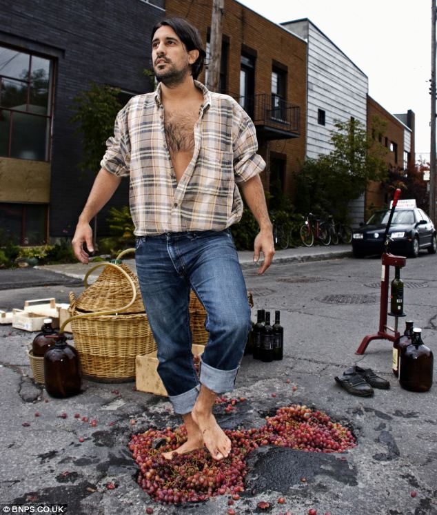 A man uses one pothole to make his own wine, stamping on grapes in a hole to get the juice