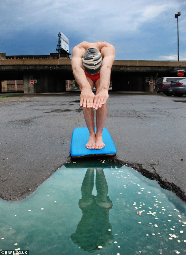 A photographer, based in New York, has been inspired to create quirky images with potholes after he damaged his car when he ran over one. Pictured is a diver diving into a 'swimming pool' pothole off a makeshift board