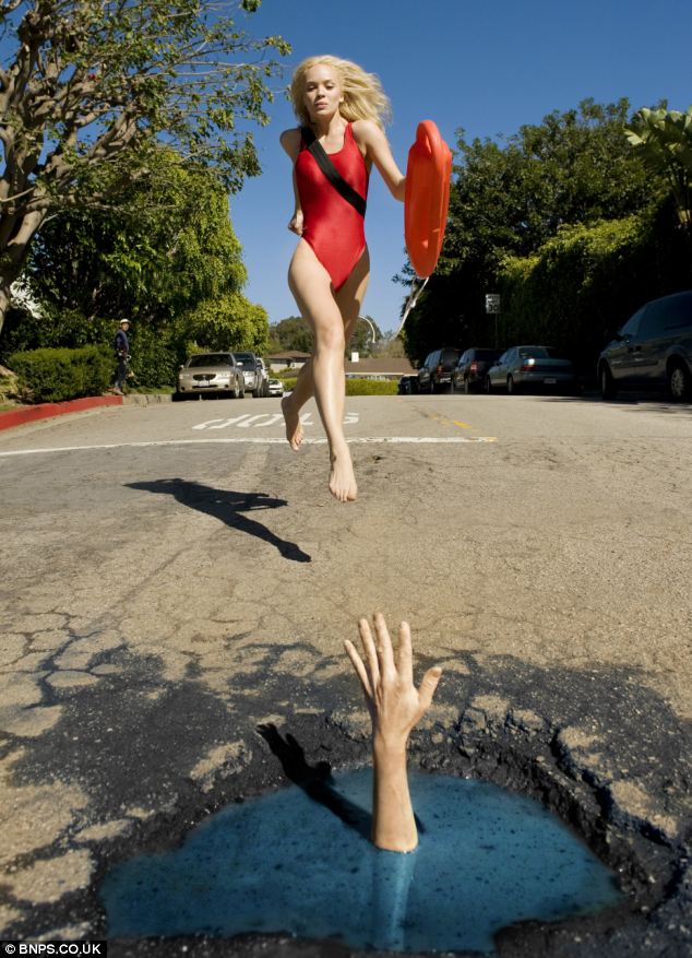 A Baywatch babe runs towards a pothole to save a person whose hand looms out from the water 