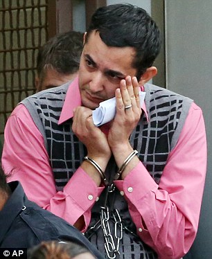 Shame: Mostafa Ahmed Awwad, 35, of Yorktown, covers his face as he leaves the federal courthouse in Norfolk