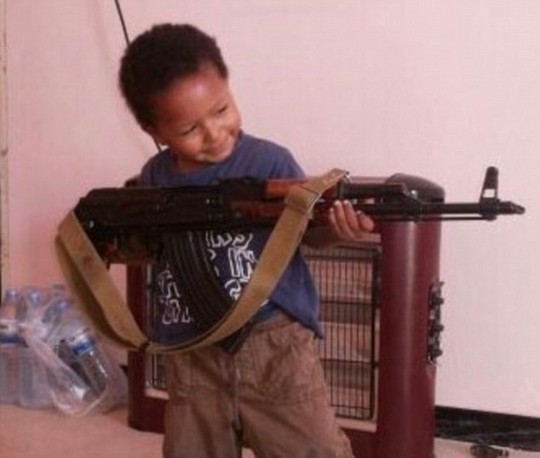 Disturbing: A Twitter post showing Dares four-year-old son grinning as he brandishes an AK-47 rifle