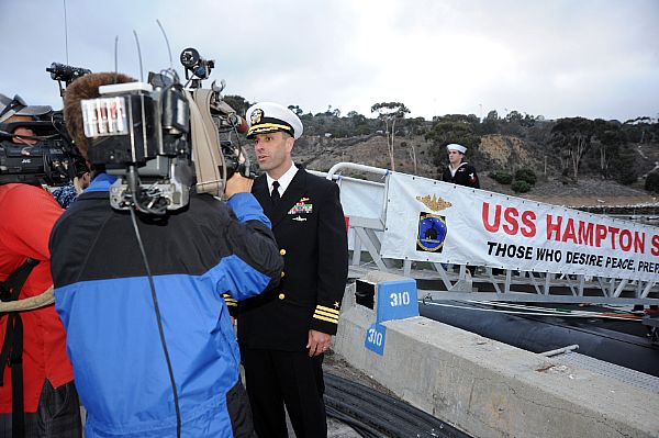 Cmdr. Lincoln Reifsteck, commanding officer of the Los Angeles-class attack submarine USS Hampton (SSN 767), answers questions during an interview with local media following a six-month deployment.