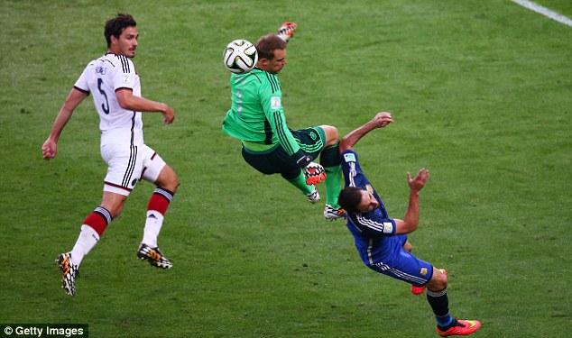 Collision: Manuel Neuer (centre) cleans out Gonzalo Higuain on the edge of the area after punching clear