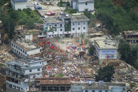 Trực thăng bay trên những ngôi nhà bị sập sau trận động đất tại thị trấn Longtoushan, tỉnh Vân Nam, Trung Quốc.