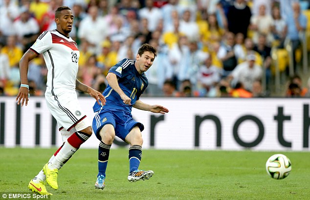Getting the shot off: Now Messi can only watch as the ball goes towards Germanys goal