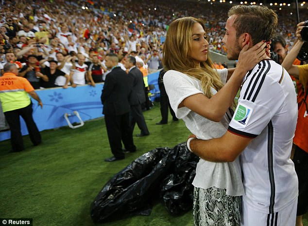 Sealed with a kiss: Gotze celebrates with girlfriend Brommel after the final whistle in Rio de Janeiro
