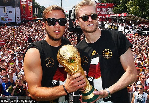 Champions: Gotze and Andre Schurrle celebrate Germanys World Cup win on their return to Berlin