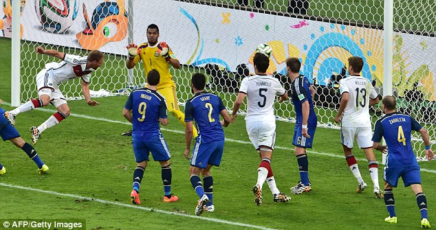 So close: Benedikt Howedes (left) heads the ball against the post from close range just before half-time