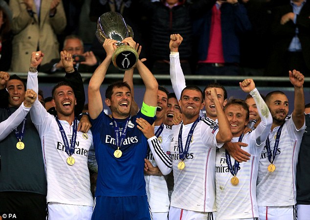 Hands on the trophy: Iker Casillas lifts the UEFA European Super Cup alongside Real Madrid team-mates