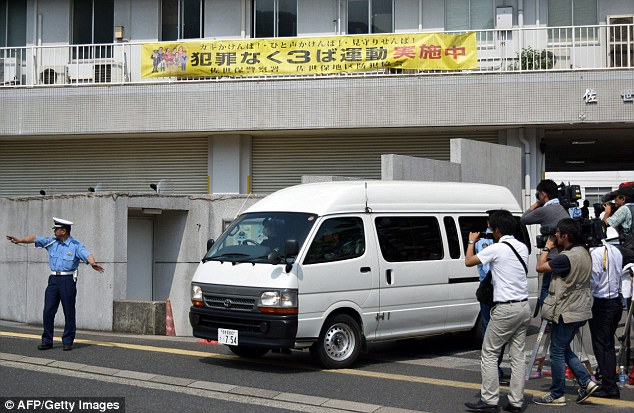 Suspect: A van carrying a 15-year-old schoolgirl - who was arrested on suspicion of killing a school friend at her home - leaves a police station for the prosecutors office in Sasebo in Nagasaki prefecture