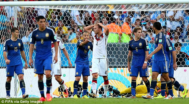 Regret: Howedes (centre) holds his head after hitting the post