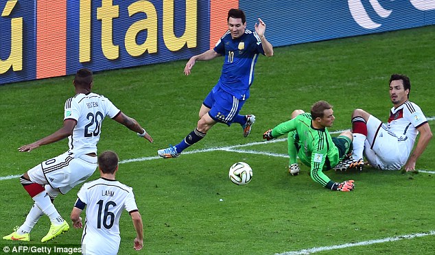 Trying to find a way through: Messi (centre) pokes the ball past Neuer but Germany clear