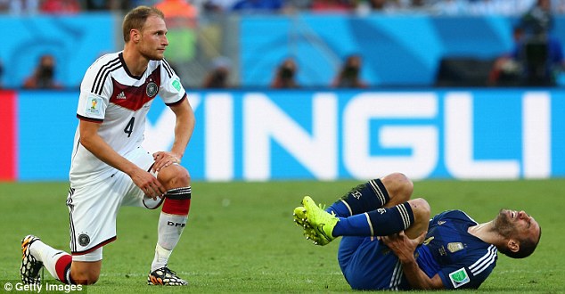 Ouch: Pablo Zabaleta (right) is down on the turf after a challenge from Howedes