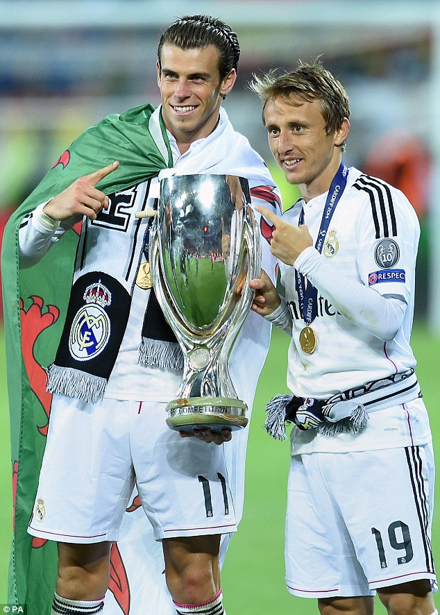 Spurred on: Former Tottenham stars Bale and Modric pose alongside the European Super Cup 