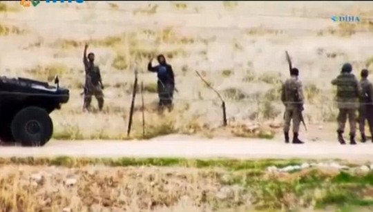 Bravado: After several minutes chatting, the militants wander off, defiantly raising their index finger to the sky to represent jihadism while chanting Allahu Akbar - a phrase that translates as God is the greatest