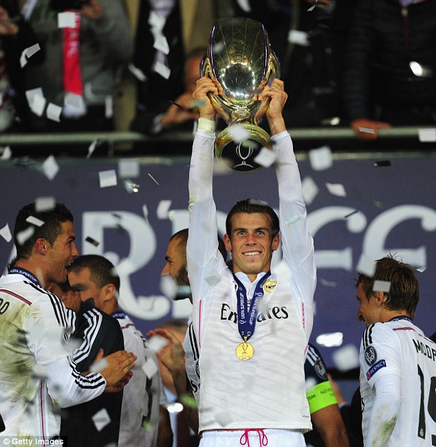 Standing proud: Gareth Bale lifts the Super Cup inside the Cardiff City Stadium following an impressive display