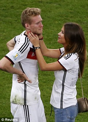 Comfort: Andre Schurrle is consoled by his girlfriend Montana Yorke after Germany won the World Cup