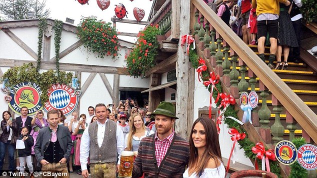 Xabi Alonso poses for pictures while clutching a pint of beer at the festival