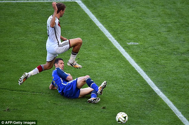 Clear: Thomas Muller is tackled by Martin Demichelis during the opening exchanges