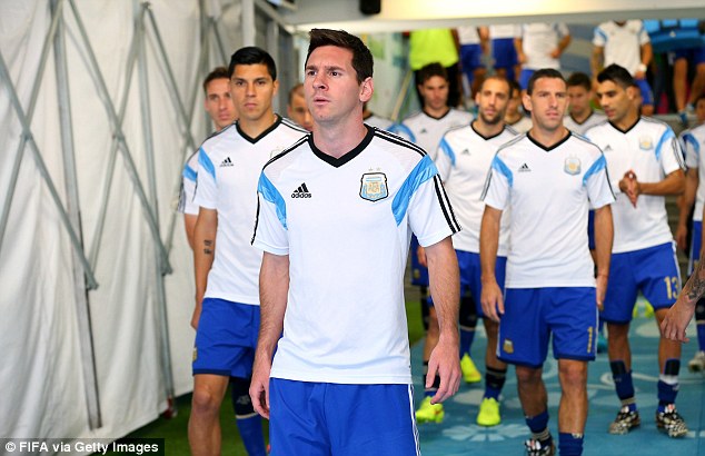 Striding out: Messi leads out the Argentina side as they go to warm-up ahead of the game