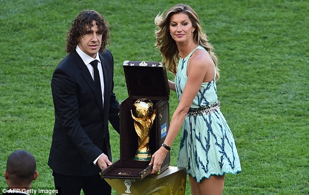 Glittering prize: Carles Puyol (left) and Brazilian model Giselle with the World Cup trophy