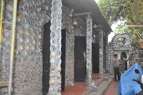 Tường mặt trước ngôi nhà được gắn bằng chén, đĩa cổ