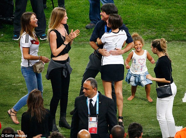 The manager, too! Joachim Low hugs his players wives and girlfriends after winning the 2014 World Cup