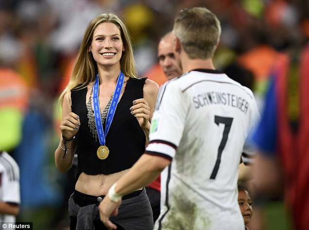 Greet: Germanys Bastian Schweinsteiger sees his girlfriend Sarah Brandner after the win