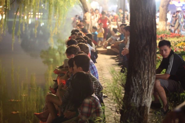 Từ gần 7 giờ tối, nhiều người đã có mặt tại Hồ Hoàn Kiếm để chờ xem bắn pháo hoa.