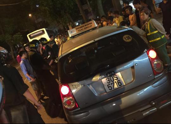Chiếc xe taxi bị lực lượng chức năng và người dân vây giữ