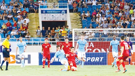 Công Phượng (giữa) tranh chấp bóng với cầu thủ Manchester City sau khi được tung vào sân những phút cuối trận. Ảnh: Như Ý.