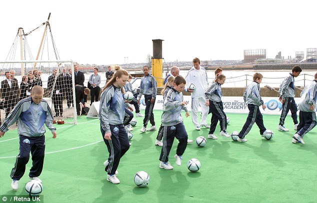 Kane, left, dribbles with ball at the launch of Beckhams academy in east London