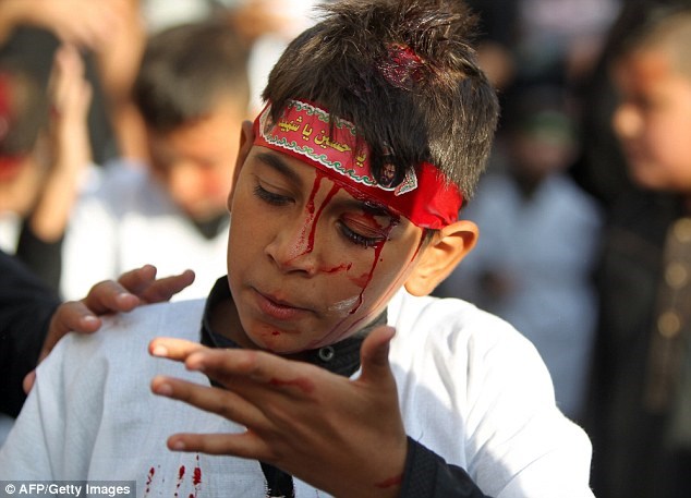 Máu chảy trên gương mặt một cậu bé tham gia nghi lễ.