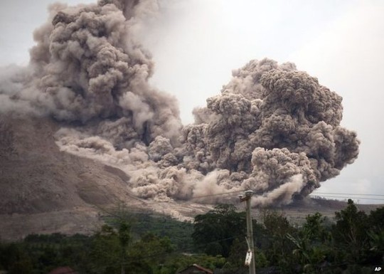 Mount Sinabung releases pyroclastic flows as seen from Tiga Serangkai, North Sumatra, Indonesia, Saturday, June 13, 2015