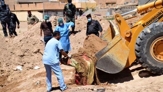 Một ngôi mộ tập thể được khai quật tại Iraq. Ảnh: EPA