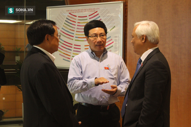 Phó Thủ tướng Phạm Bình Minh (đứng giữa) trao đổi với một số ĐBQH.