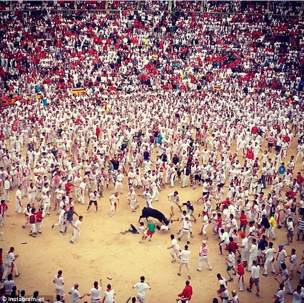 July 8th: Spain's the Running of the Bulls earned third place with this astonishing photo of at least two men knocked flat on their backs from a loose bull