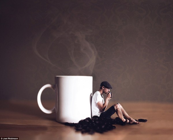 Caffeinated: Joel relaxes with a tiny mug of coffee, as he leans against a giant one