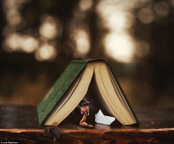 Stuck Inside: On a rainy day, school support worker Joel takes shelter under a book