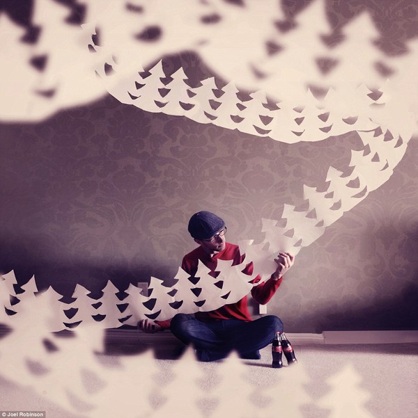 Coca-Cola Christmas: Joel observes a string of paper Christmas trees for a festive commission from the drinks company