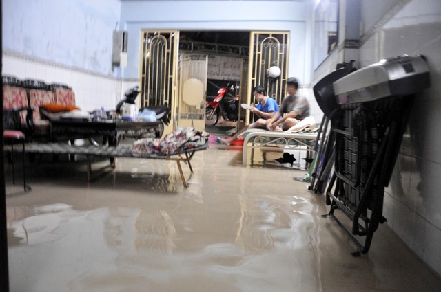 Tại các tuyến đường Tân Hòa Đông, An Dương Vương (quận 6) nước cũng bị ngập sâu. Nước tràn vào nhà, người dân hì hục tát nước ra ngoài.