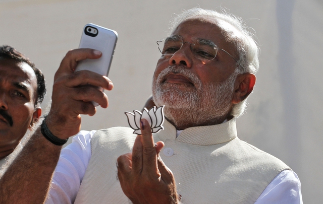 Ngày 30/4/2014, ứng cử viên Thủ tướng Ấn Độ Narendra Modi cầm biểu tượng của đảng Nhân dân, chụp hình tự sướng sau cuộc bỏ phiếu tại Ahmedabad.