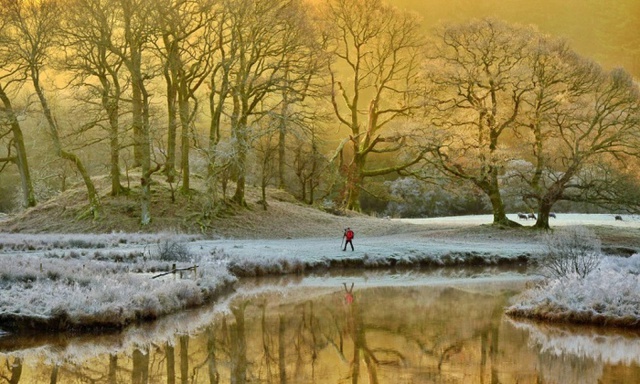 Người dân đi bộ dọc sông Brathay trong buổi sáng mùa đông lạnh giá ở quận Lake, Cumbria, Anh.