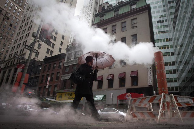 Một người đi bộ qua ống hơi nước ở Manhattan,  New York, Mỹ.