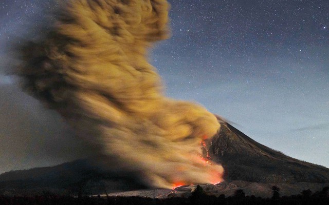 Cảnh tượng núi lửa Sinabung phun trào được chụp từ ngôi làng Beganding ở Karo, tỉnh North Sumatra, Indonesia.
