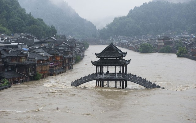 Một cây cầu ngập trong nước lũ sau nhiều ngày mưa lớn tại thị trấn cổ Phượng Hoàng, tỉnh Hồ Nam, Trung Quốc.
