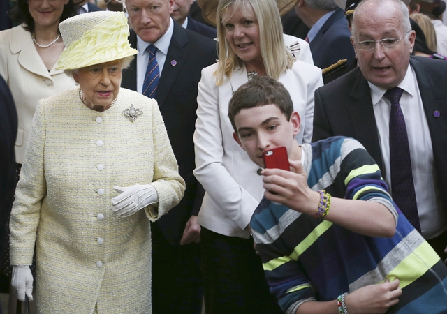 Ngày 24/6/2014, một cậu bé to gan chụp hình tự sướng với Nữ hoàng Anh Elizabeth II, tại thủ đô Belfast của Cộng hòa Bắc Ireland, khi Nữ hoàng đi thị sát. Nguồn: dfic.cn